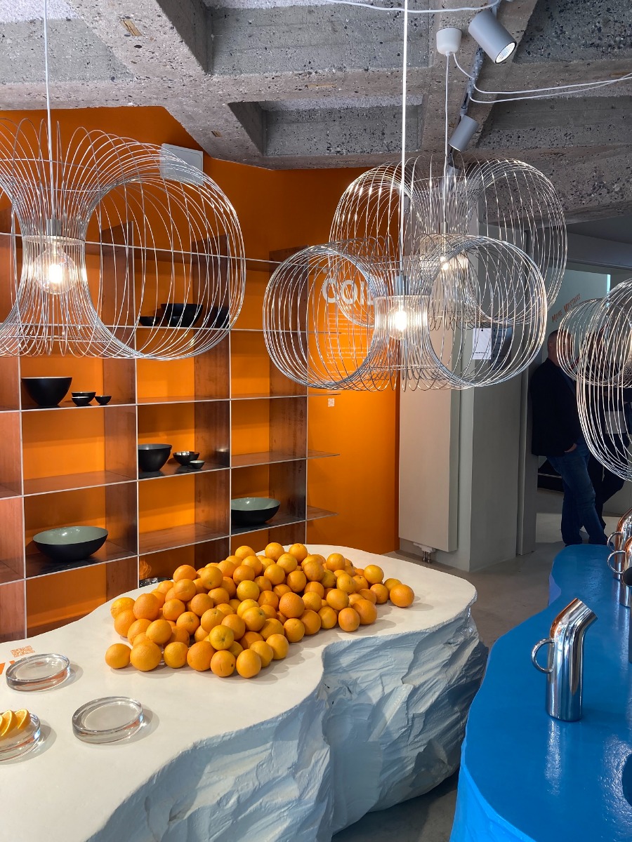 Normann Copenhagen Coil pendants clustered around a table