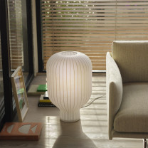 Muuto Stand Table Lamp 59 next to sofa