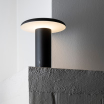 Artemide Takku LED Portable Table Lamp Lifestyle Shelf