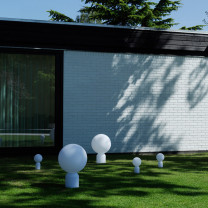 Normann Copenhagen Yo Table Lamp on garden lawn